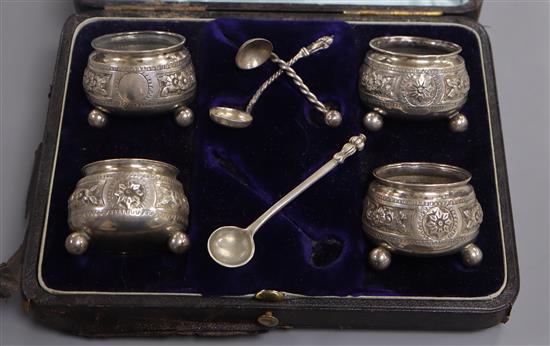 A cased set of four Victorian silver salts by George Unite, Birmingham, 1881, with one original spoon and two associated spoons.